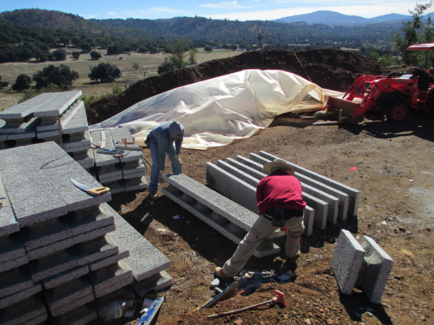 Workers moving the large perform wall panels.